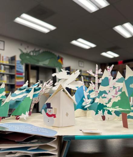 pop up book open to see winter landscape with snowman