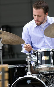 Portrait of Matt behind a drum kit.