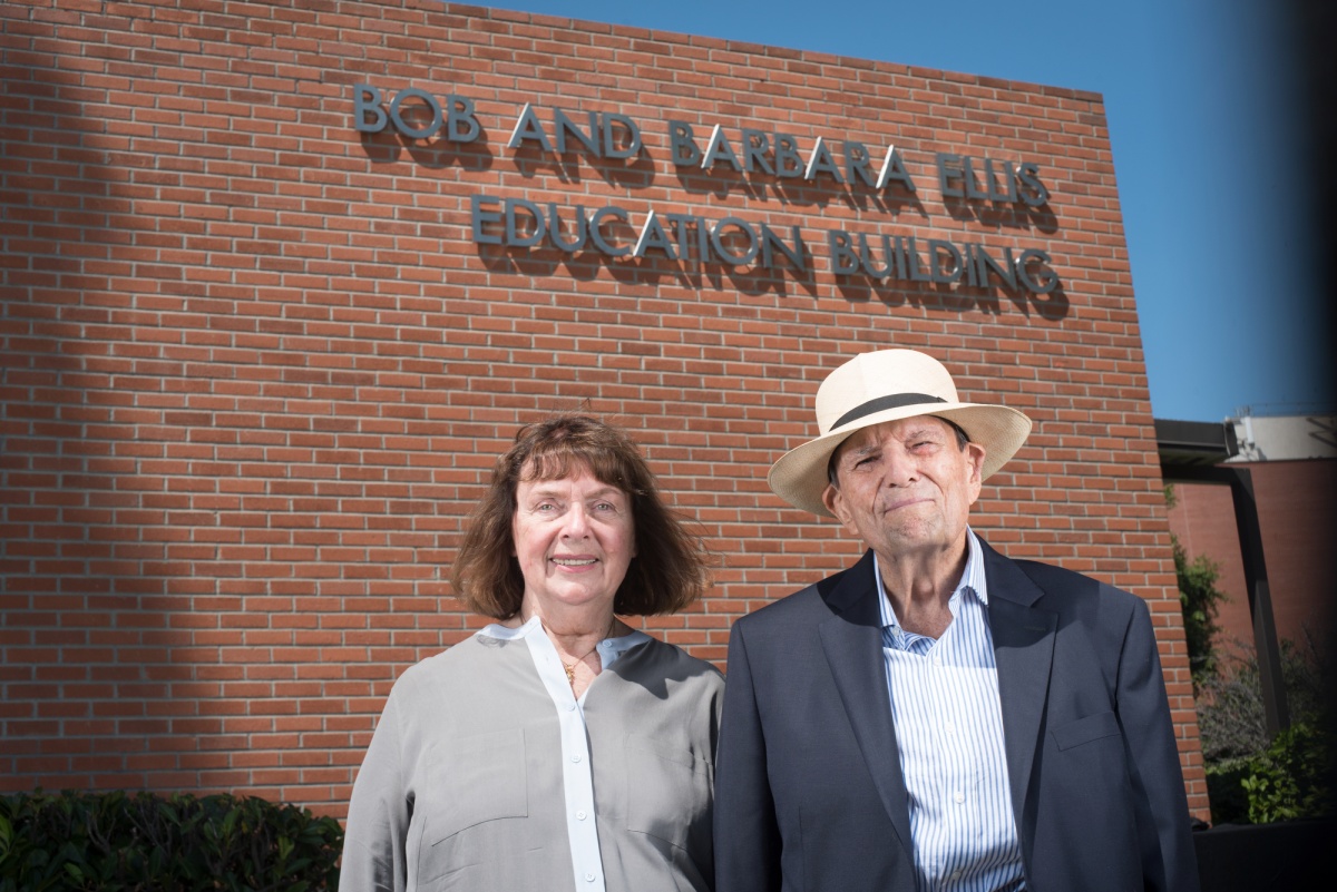 Bob and Barbara Ellis pose in front of the CSULB building na