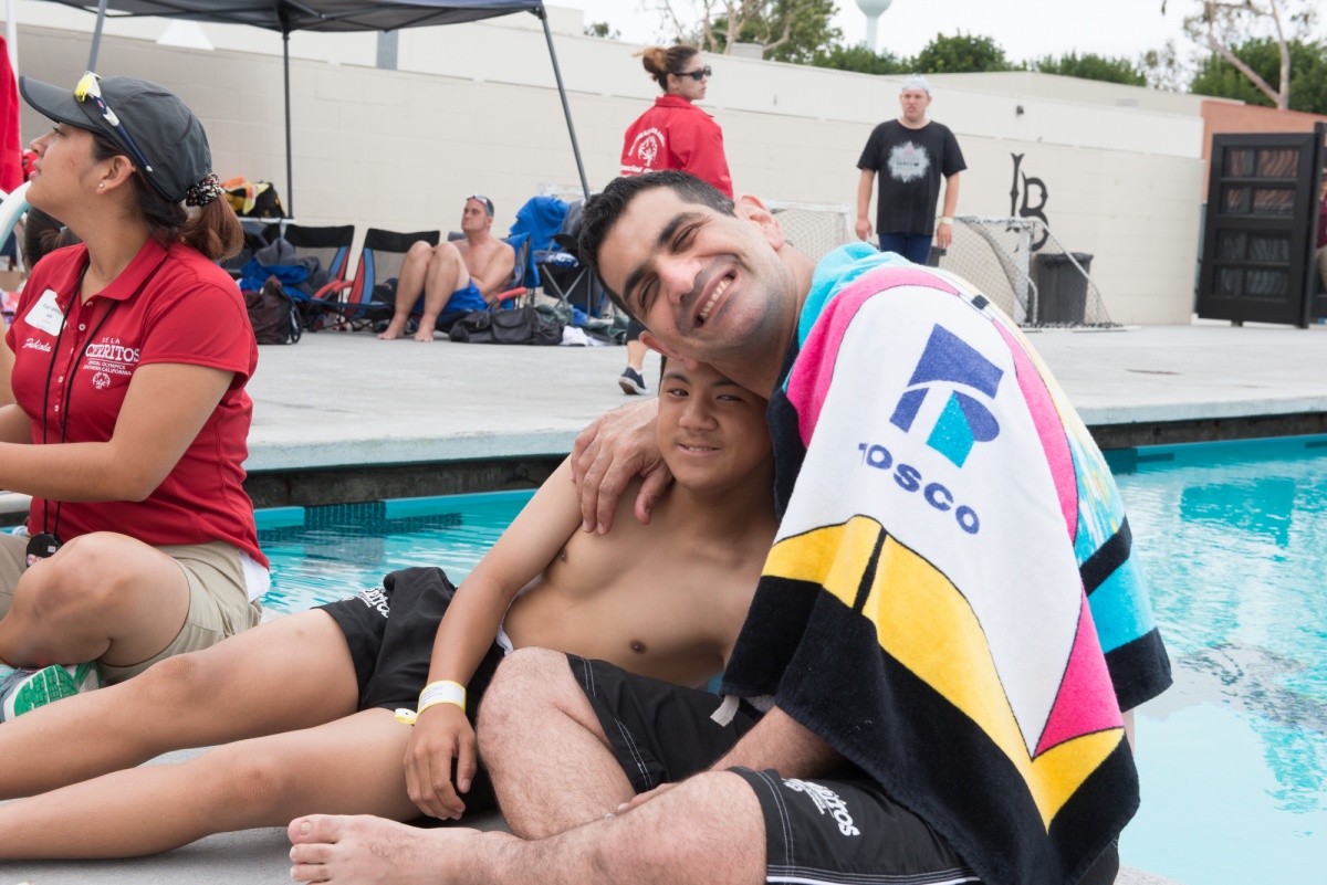 Two swimmers embrace. Bonding moments at the Summer Games. 