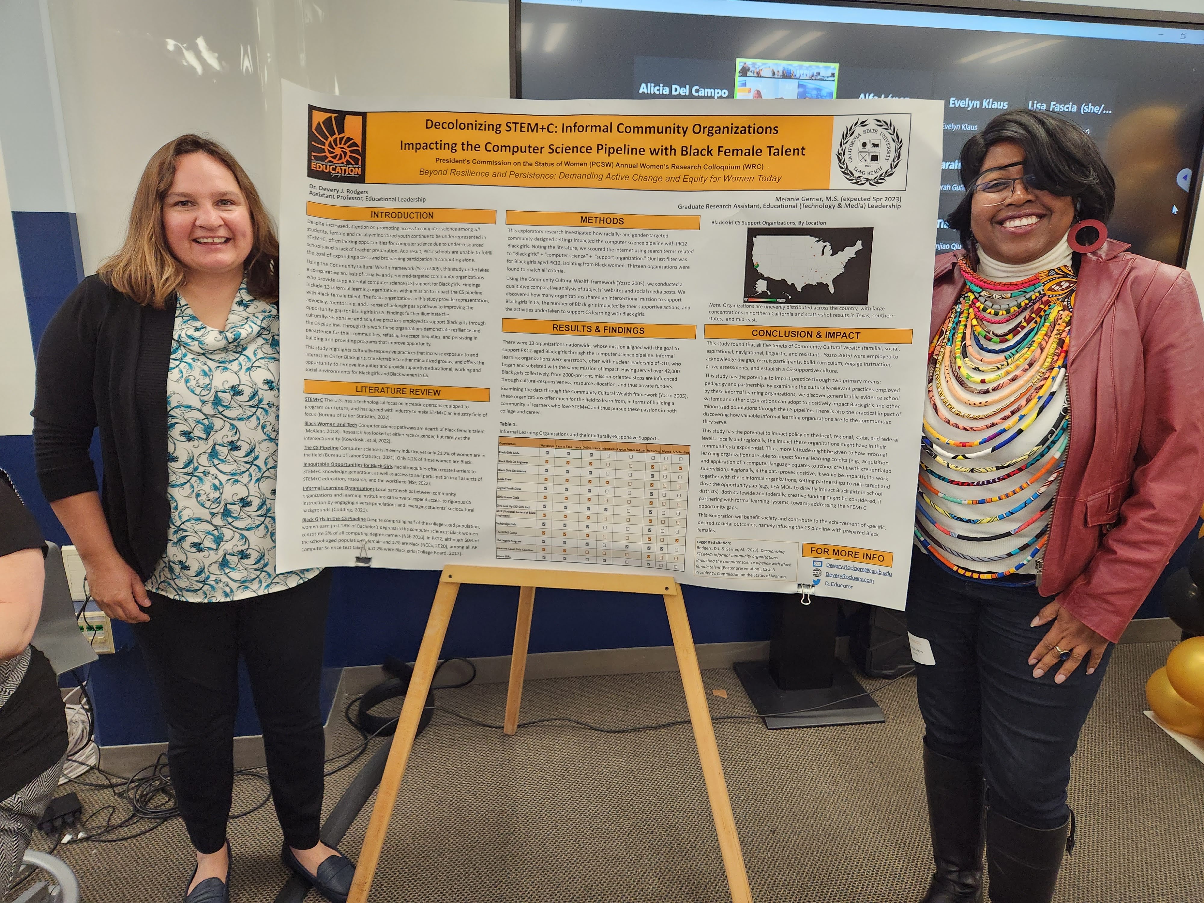 Melanie Gerner and Devery Rodgers stand by a poster showcasing their research