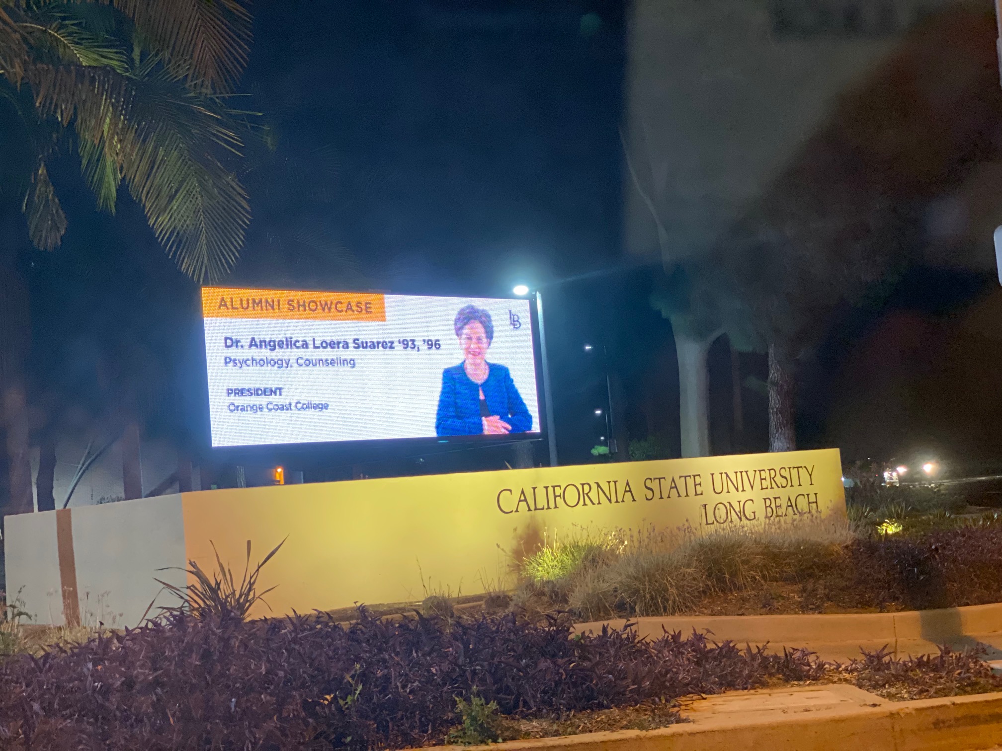 A CSULB billboard features a picture of and information about alumna Angelica Suarez
