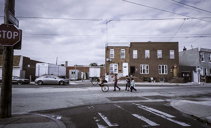 screen shot - kids walking across an inner city street