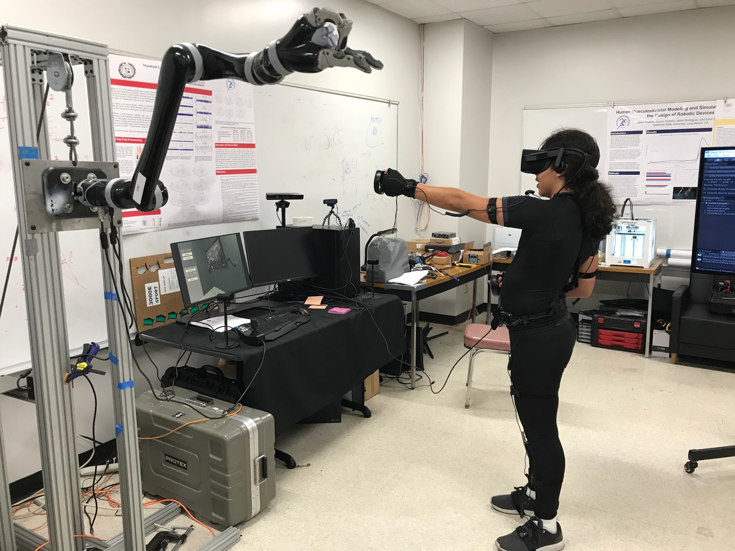 Image of graduate student controlling a robot from within a 