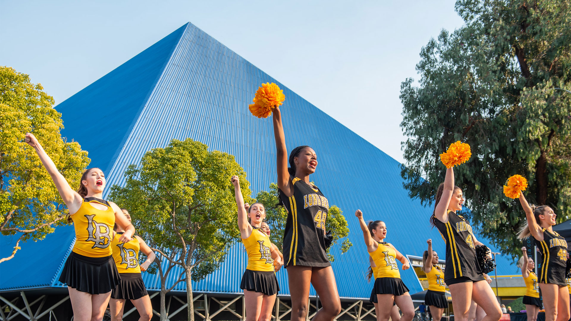 cheerleaders in front of pyramid