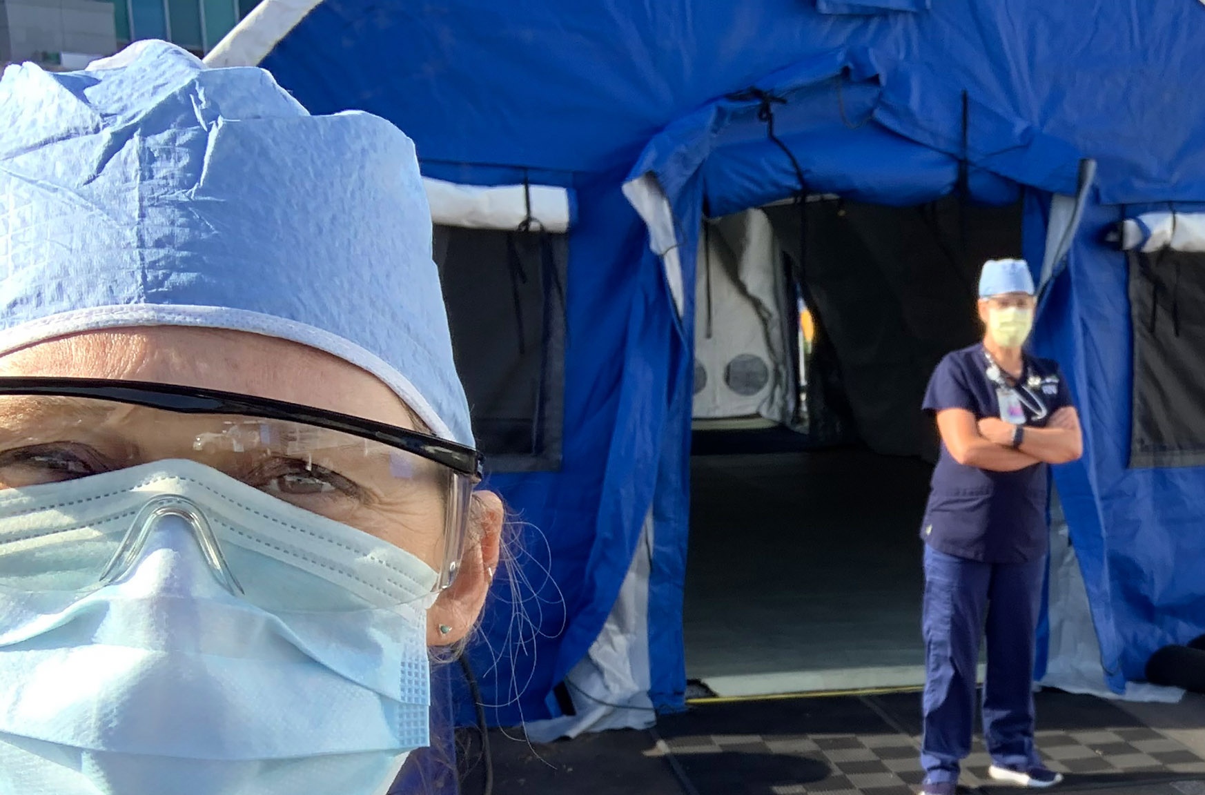 nurse tassia trink stands near tent