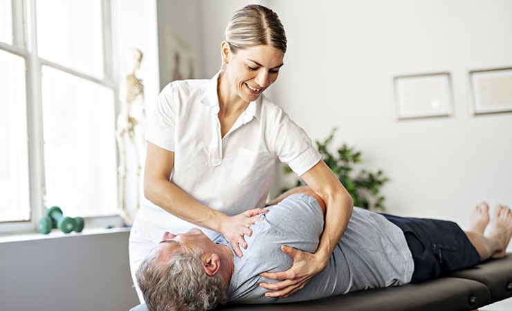 Physical therapist working with senior client