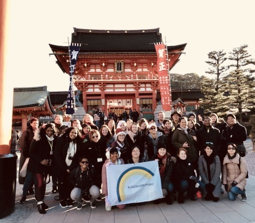 Group takes picture at Tourist attraction in Japan.