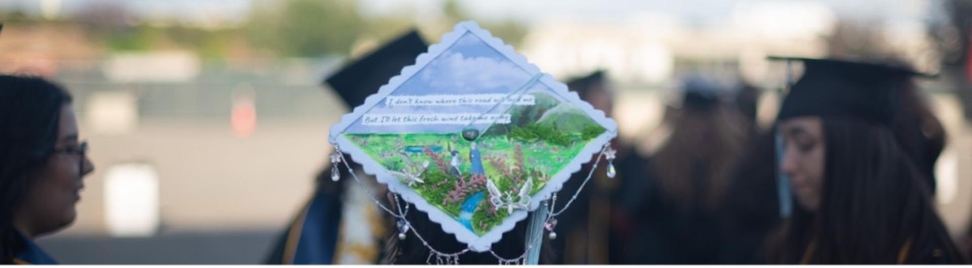 Close up of grad cap among group of college graduates at commencement