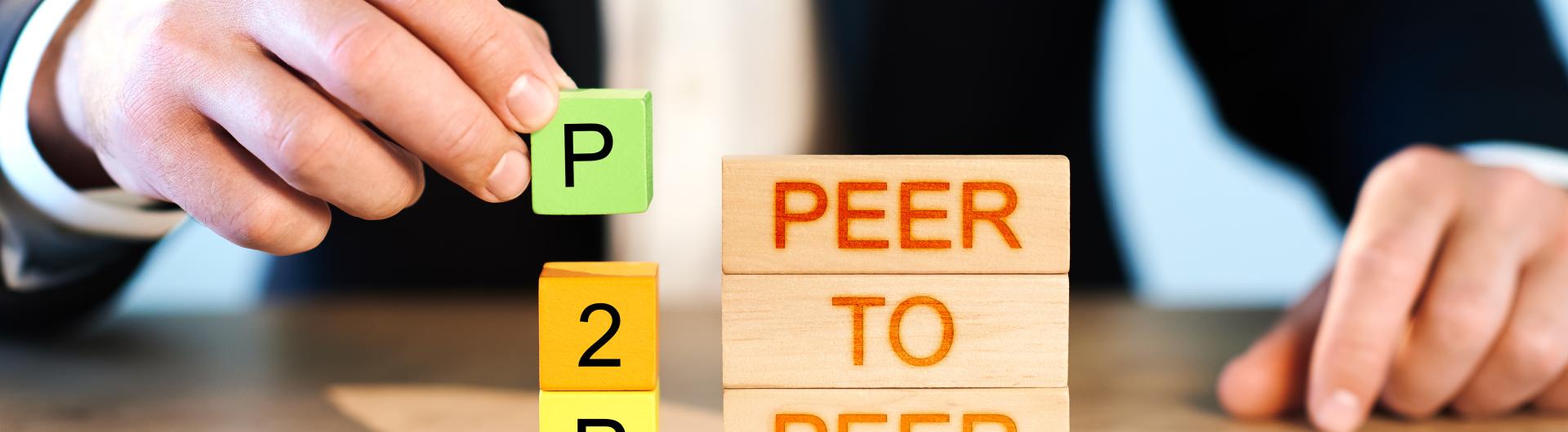 Man stacking P2P Peer to Peer blocks