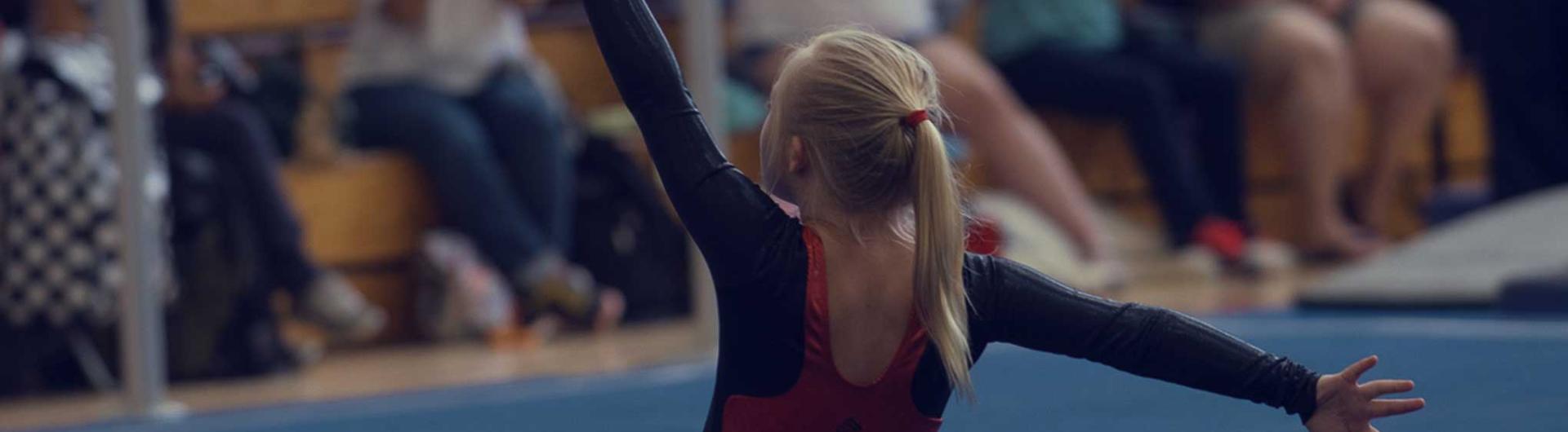 Special Olympics competitor competes in gymnastics. 