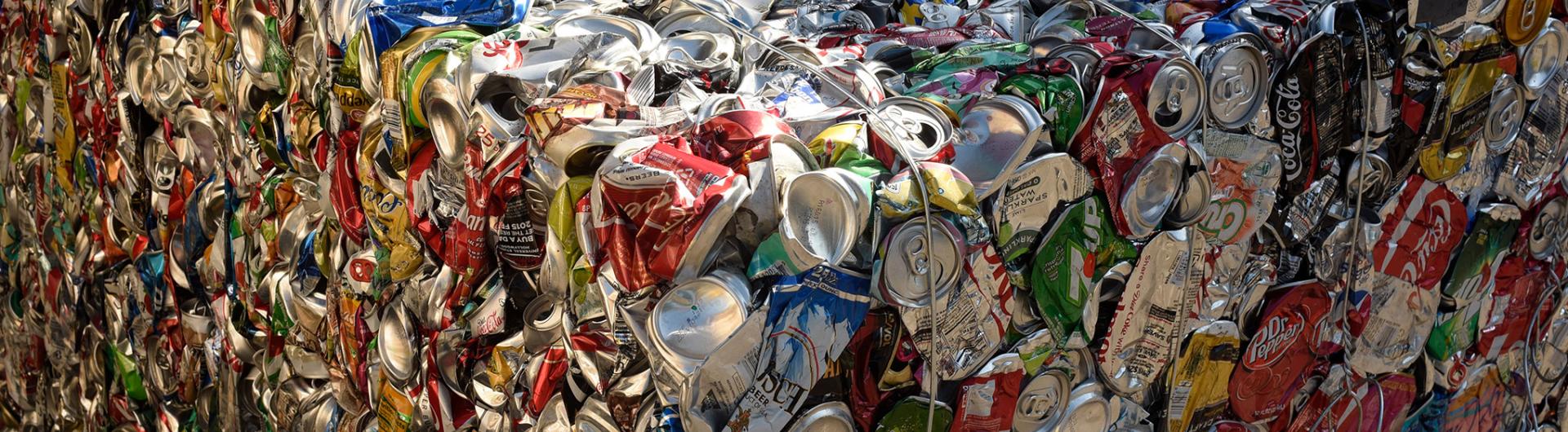 Close up of crushed soda cans showcasing recycling efforts. 