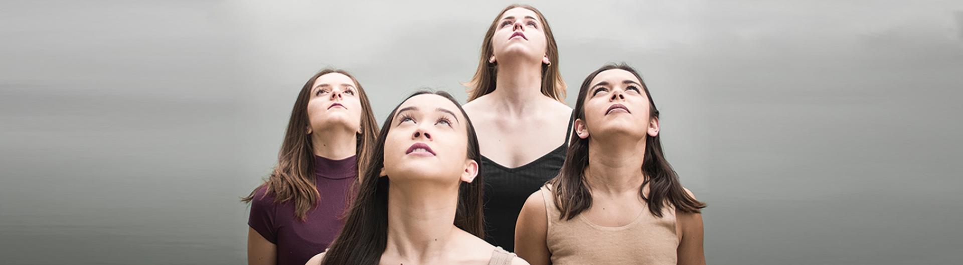 Four female choreographers look up towards the sky