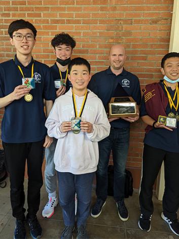 Math Day winners holding trophies and medals