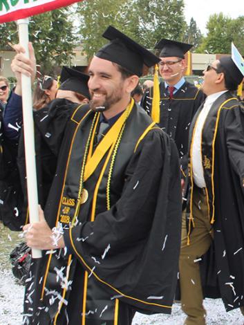 graduating students walking through confetti
