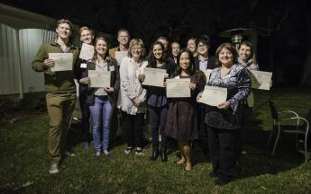 President Conoley celebrates with Public Knowledge Media Training faculty and graduate students at the Miller House on Nov. 29.