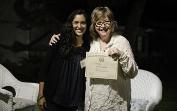 Graduate student Lorena Silva accepts her Public Knowledge Media Training certificate of completion from President Jane Close Conoley.