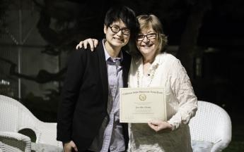 Mathematics Associate Professor Jen-Mei Chang accepts her Public Knowledge Media Training certificate of completion from President Jane Close Conoley.