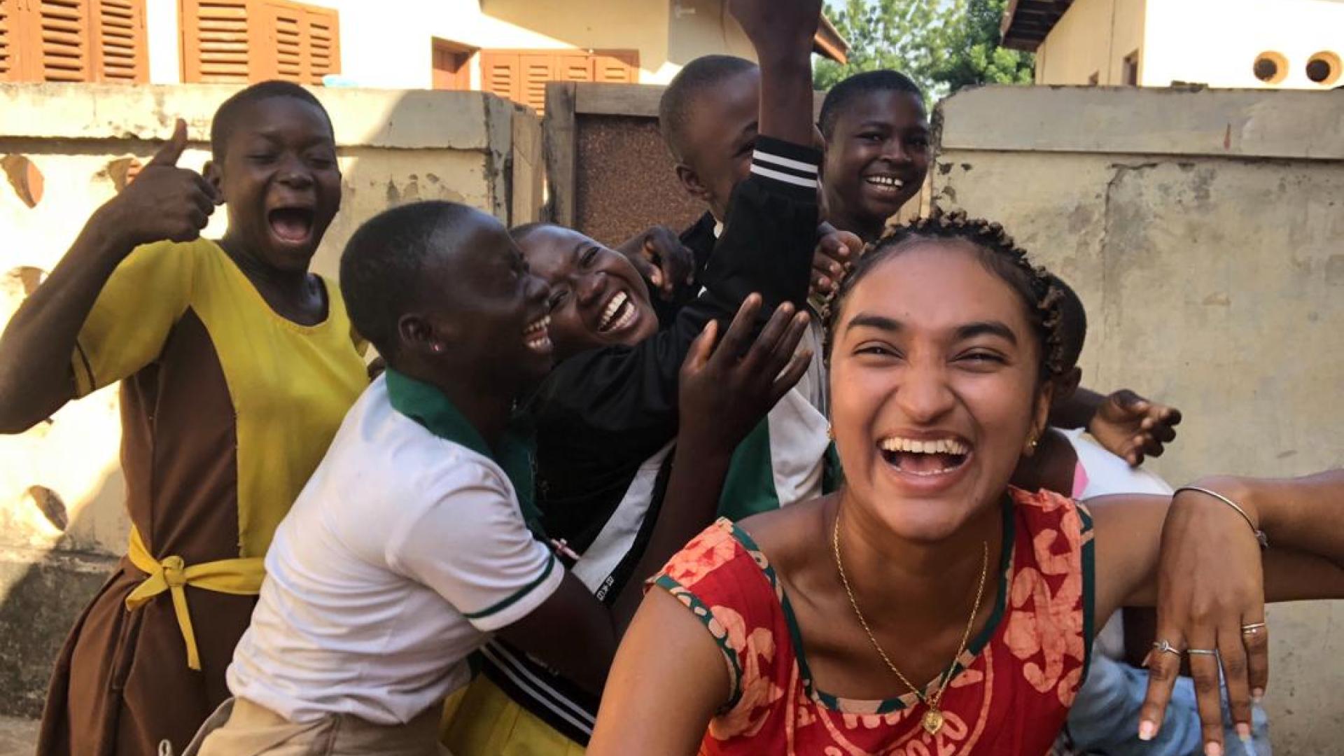 Peace Corps student laughs with friends