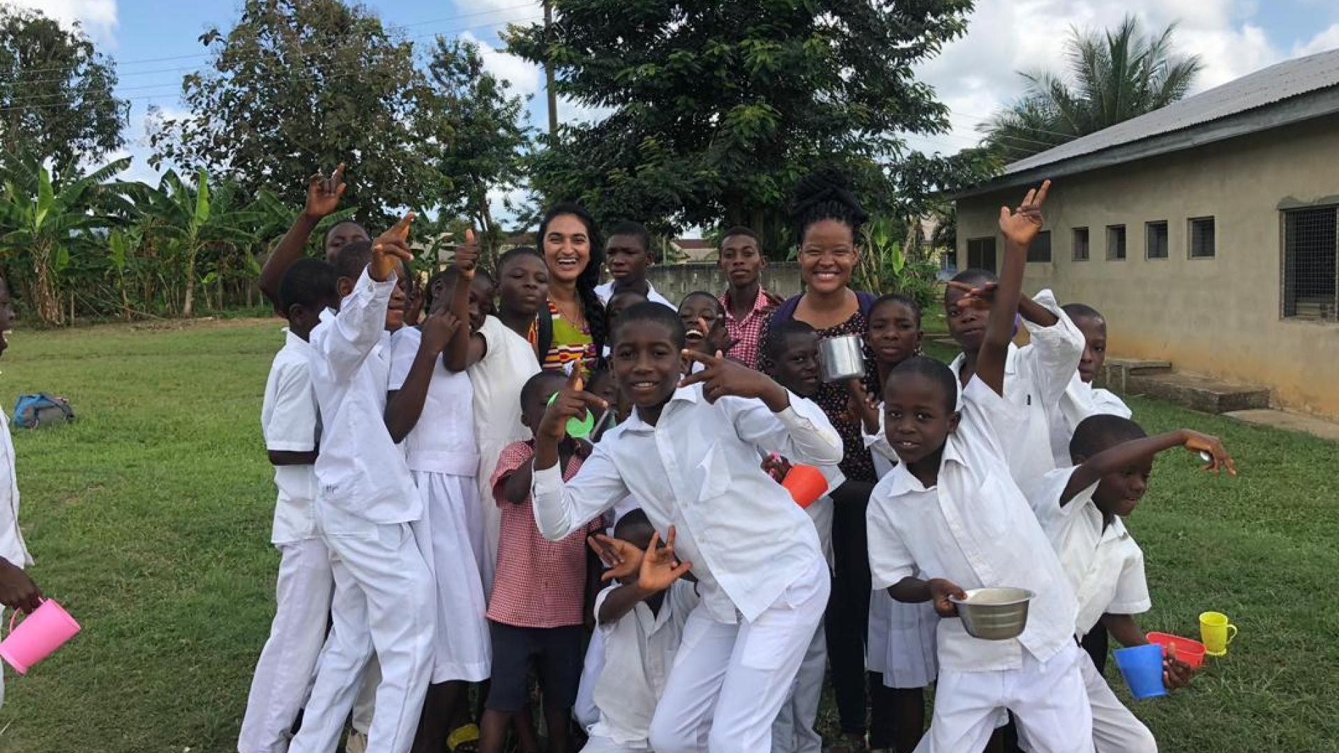 Peace Corps student surrounded by kids