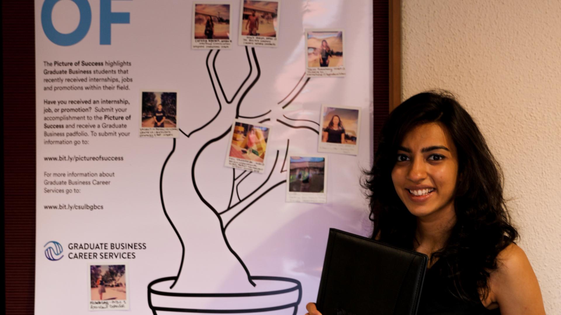 Vandana Vaswani in front of the Picture of Success Poster