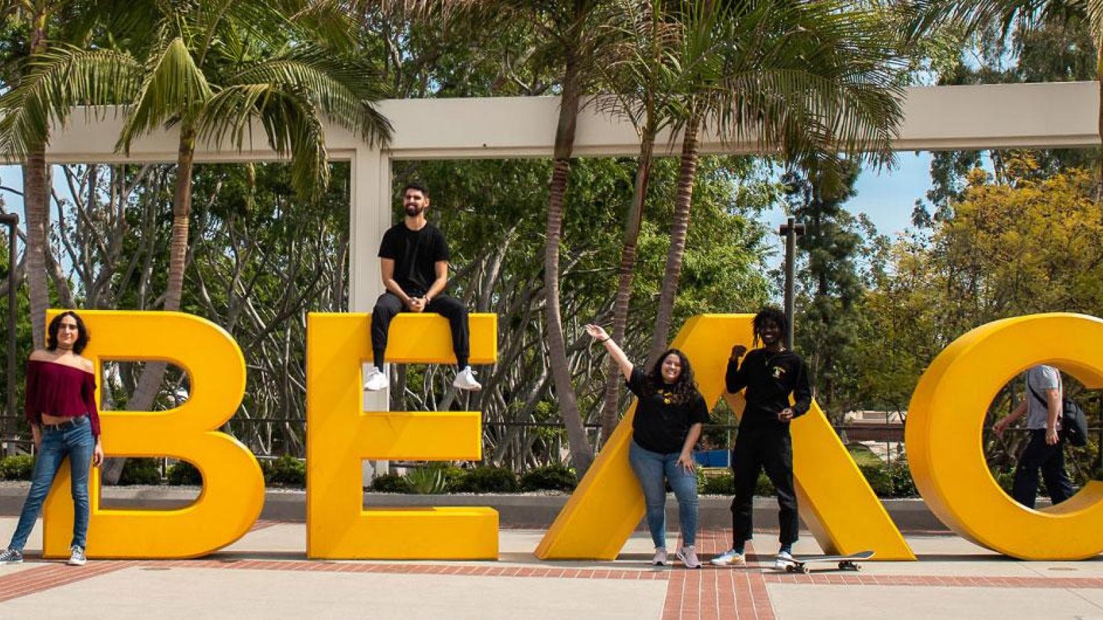 Go Beach sign with students posing