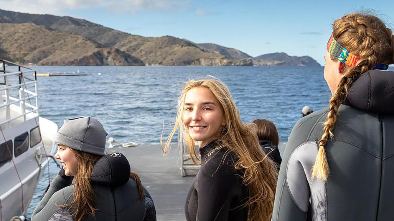 students in wetsuits on a boat near Catalina