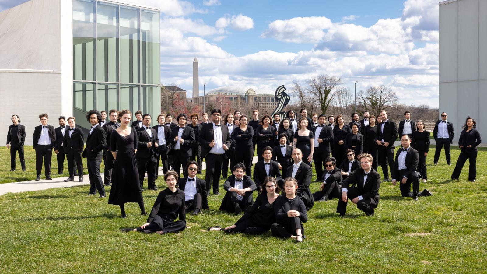 CSULB Wind Symphony Members pose on a grass lawn in Washington D.C.