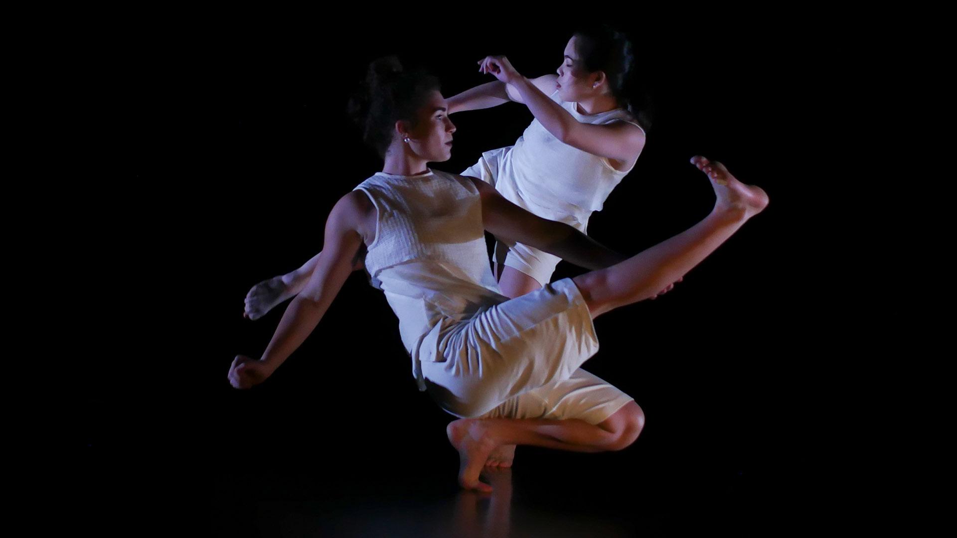 Two dancers kicking their legs