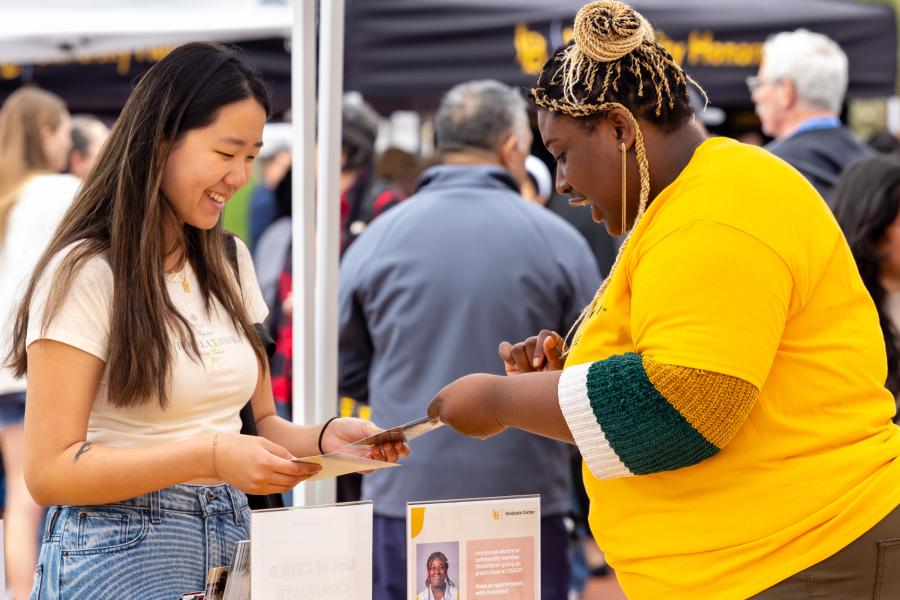 An admitted student gathers information at one of hundreds of booths during 'Day at The Beach'
