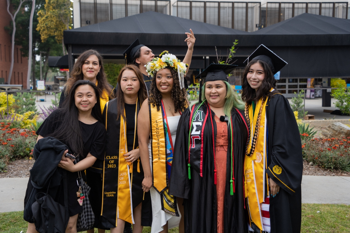 Group of graduating students stand together.