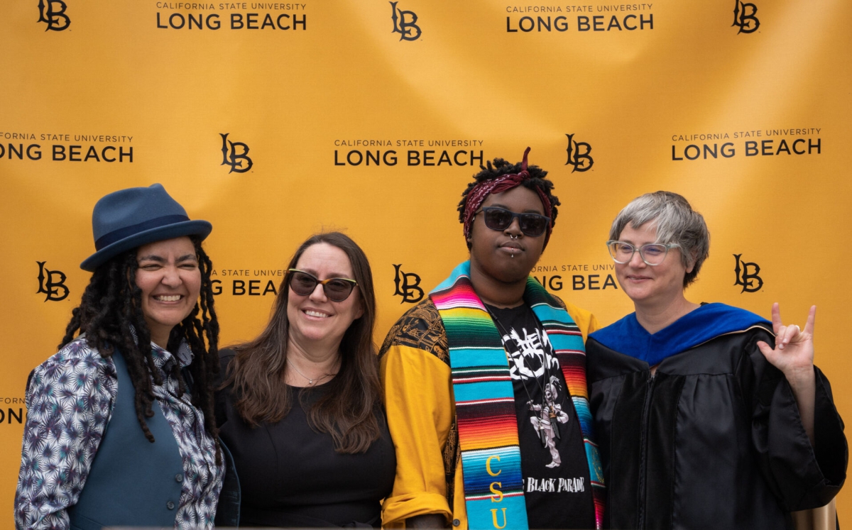 Group of ASLD faculty stand tigether at grad ceremony.