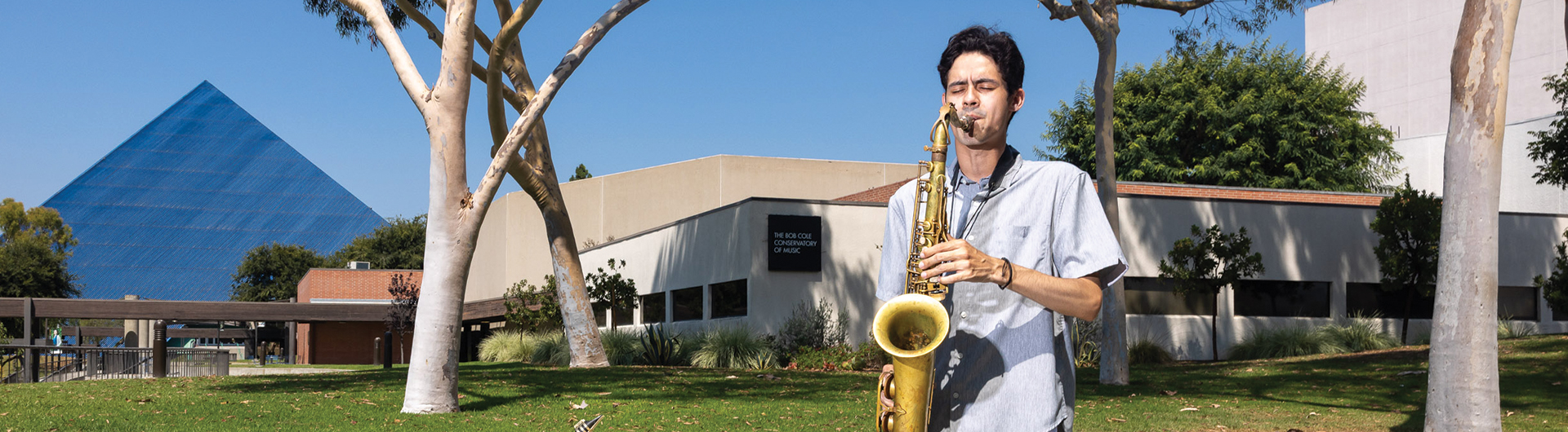 Christian Basabro plays the saxophone with Pyramid behind him