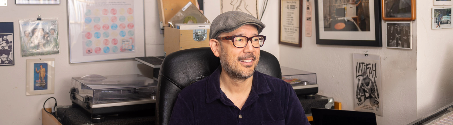Professor Oliver Wang smiles in his office