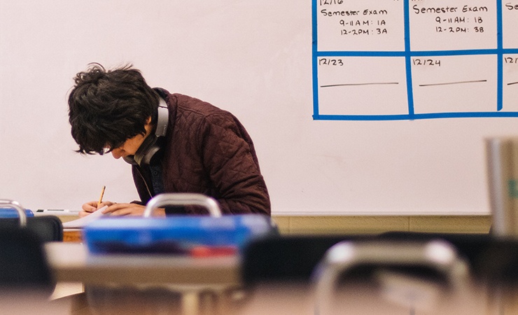 student taking exam in classroom