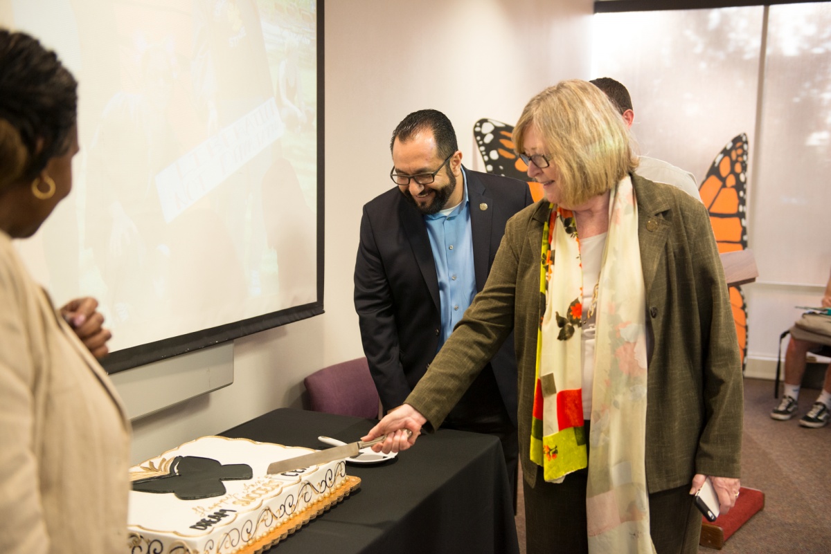 President Conoley cuts the first piece of cake