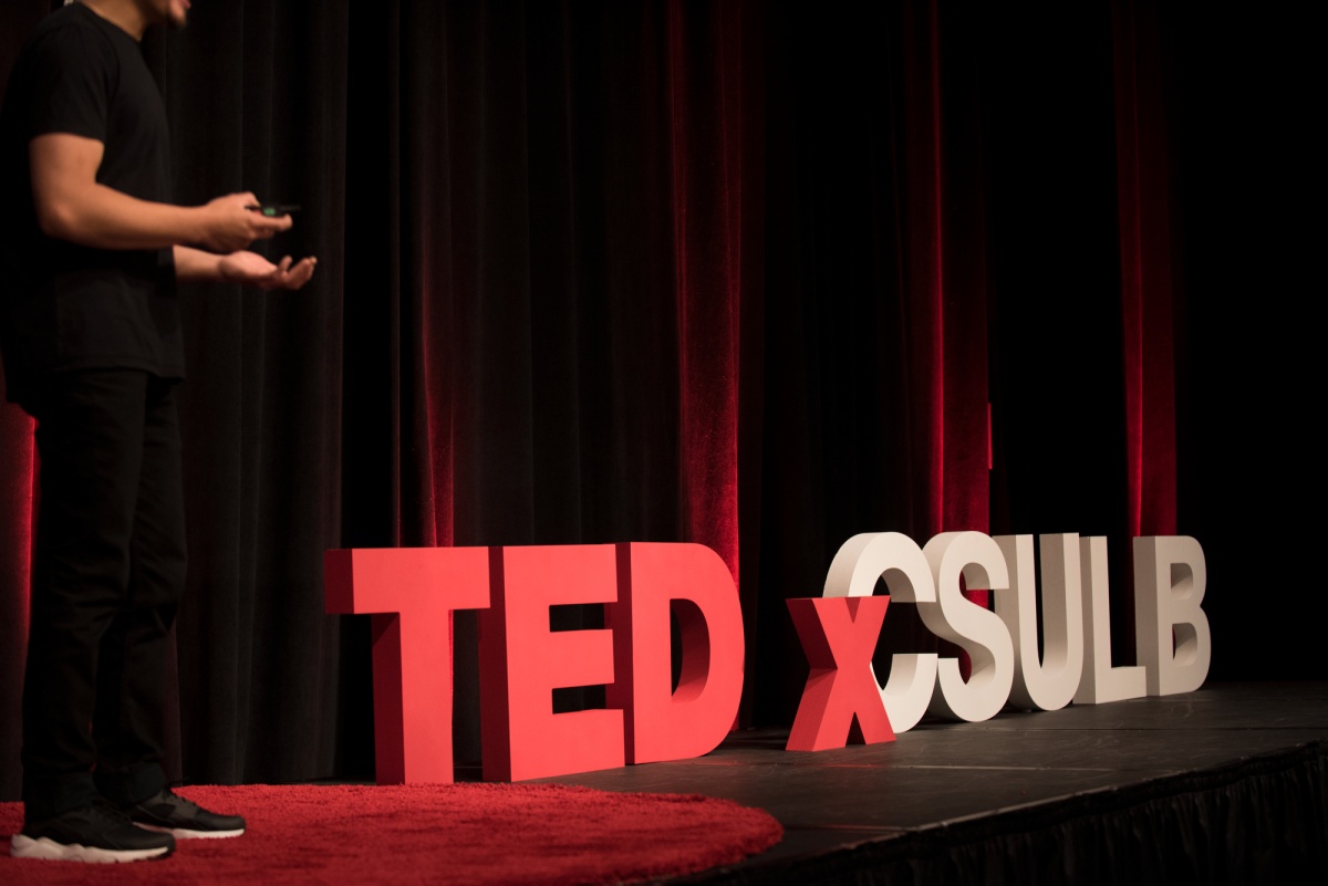 Presenter on stage at TEDxCSULB