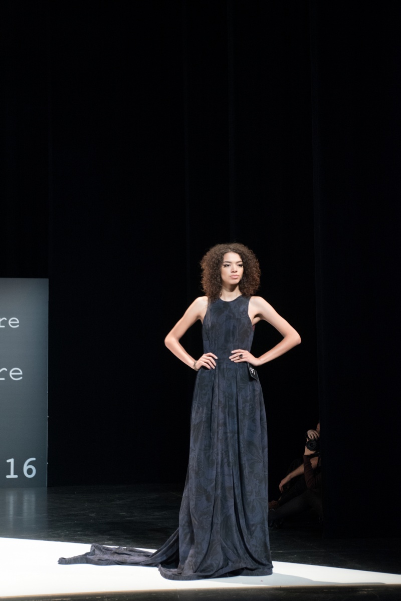 A model poses at the end of the runway in a student-designed