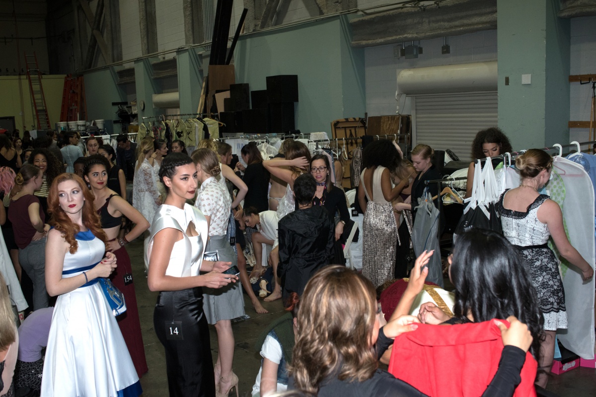 A backstage shot shows the work put into the runway show.