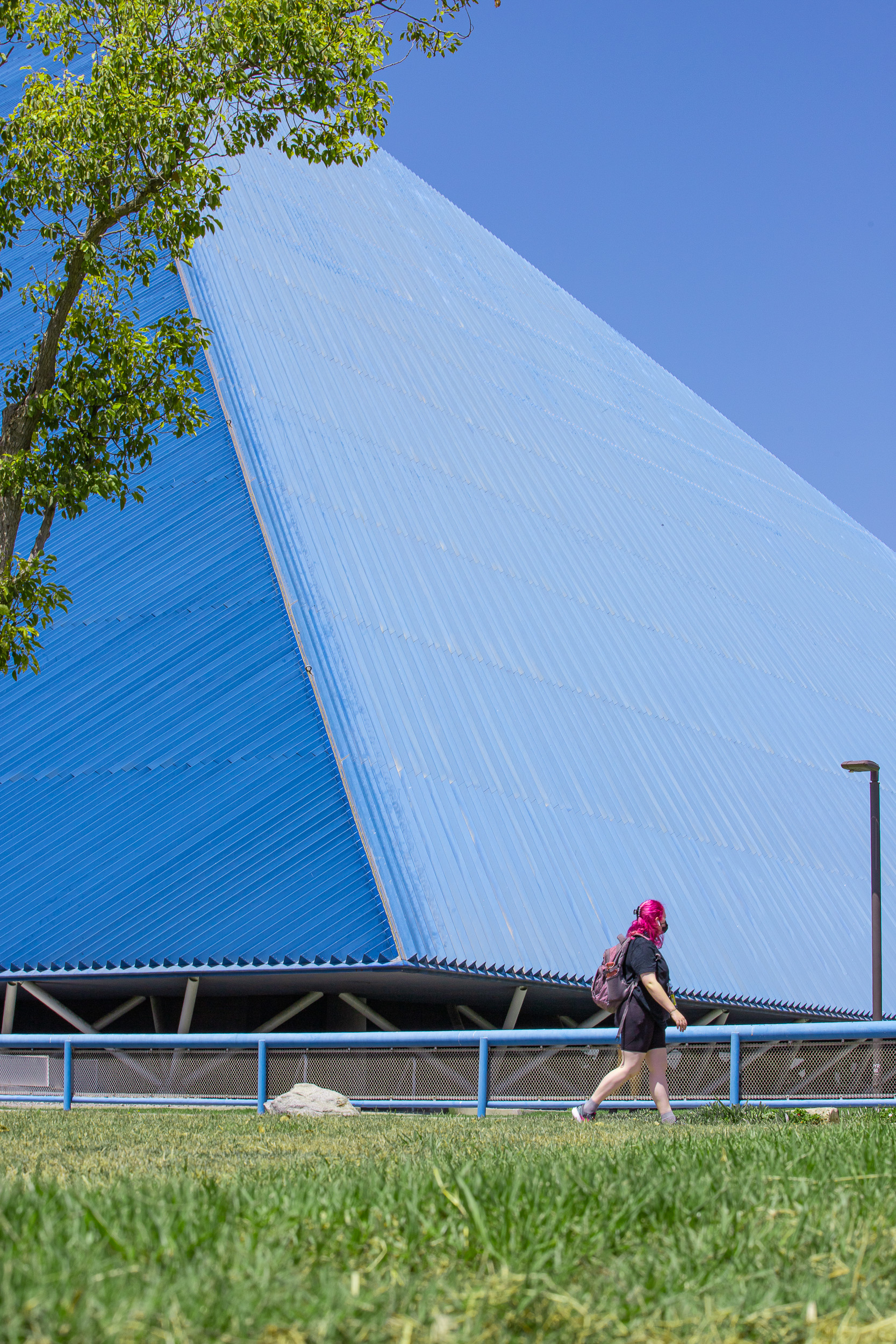 Student walks in front of Walter Pyramid