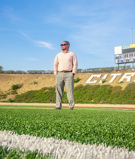 Alumnus Junior Domingo stands on Citrus College football field