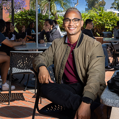 Austin Metoyer sitting at tables near COB