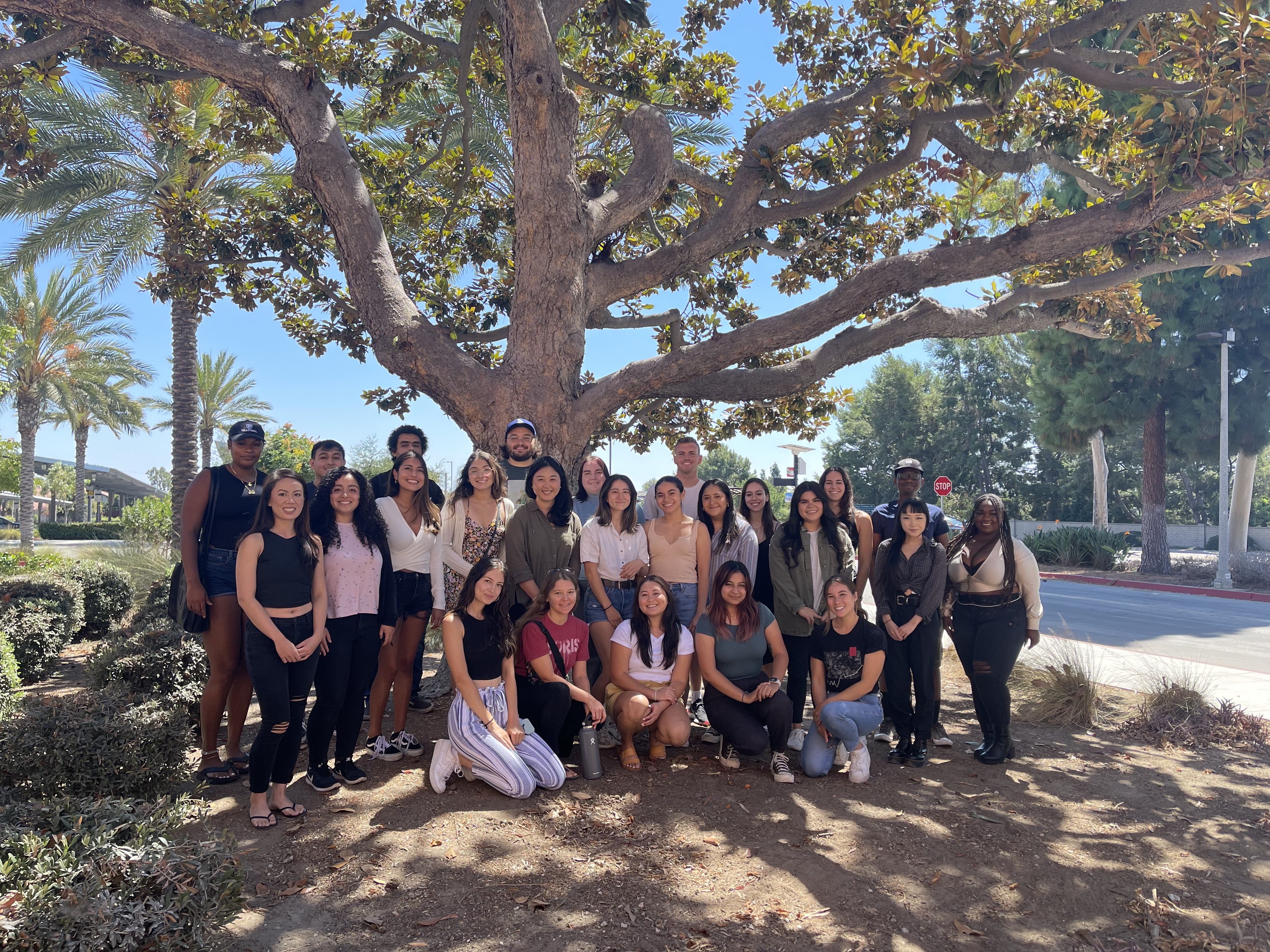Group of students in the School Psychology program pose under a tree