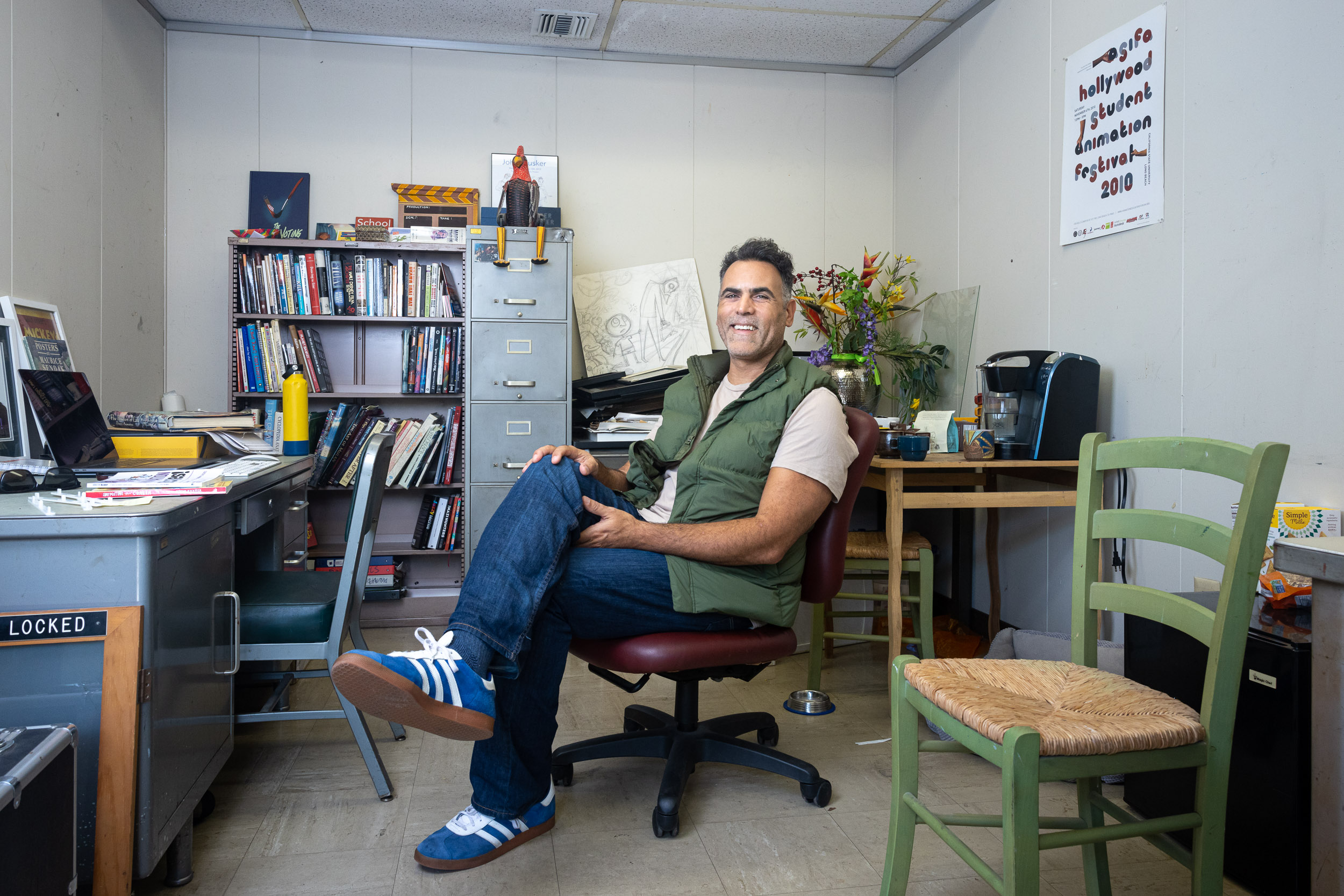 Professor Aubrey Mintz sitting in a chair in his office