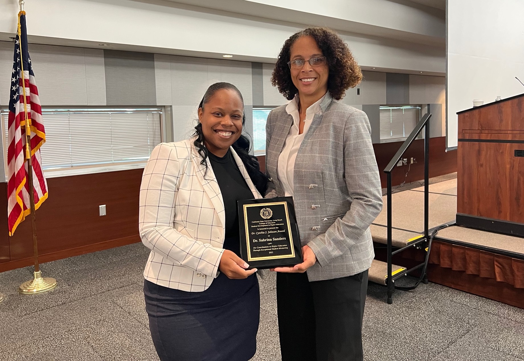 Dr. Autumn Cunningham (left), a lecturer in Cal State Long Beach’s Educational Leadership Department, presents Dr. Sabrina Sanders with this year’s Cynthia Johnson Award for Mentoring Oct. 14.