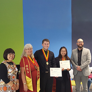 group of people holding certificates