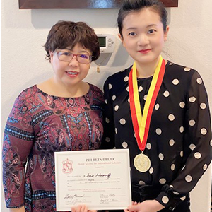 two people holding certificates