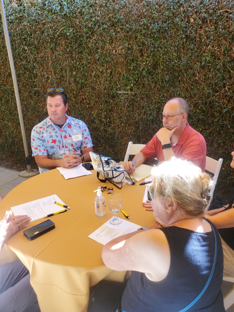 A group of people talking at a round table