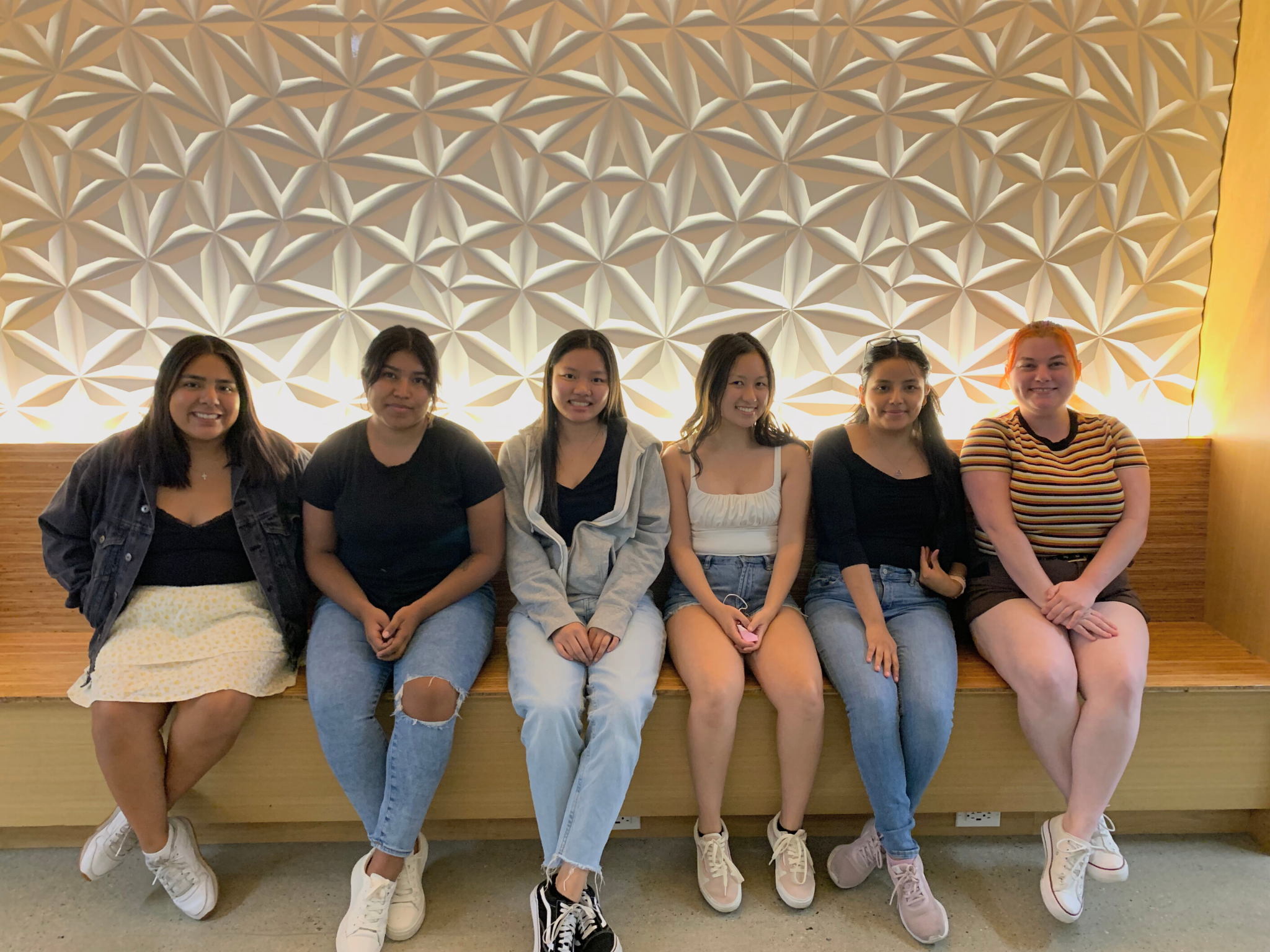 The Womxns Collective council sitting on a bench