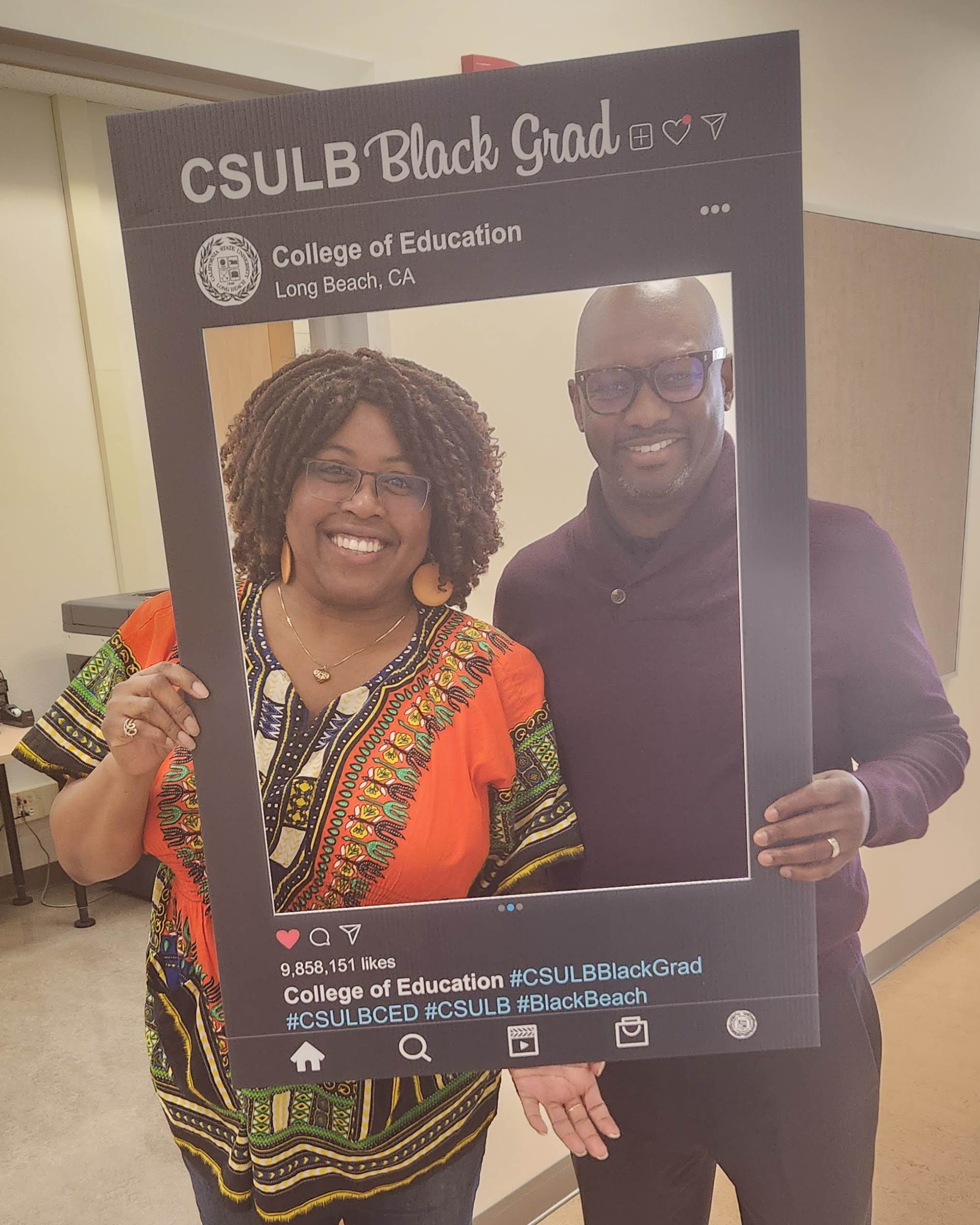 Two people pose at a CSULB Black Grad selfie station